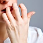 anxiety and stress, nail-biting woman